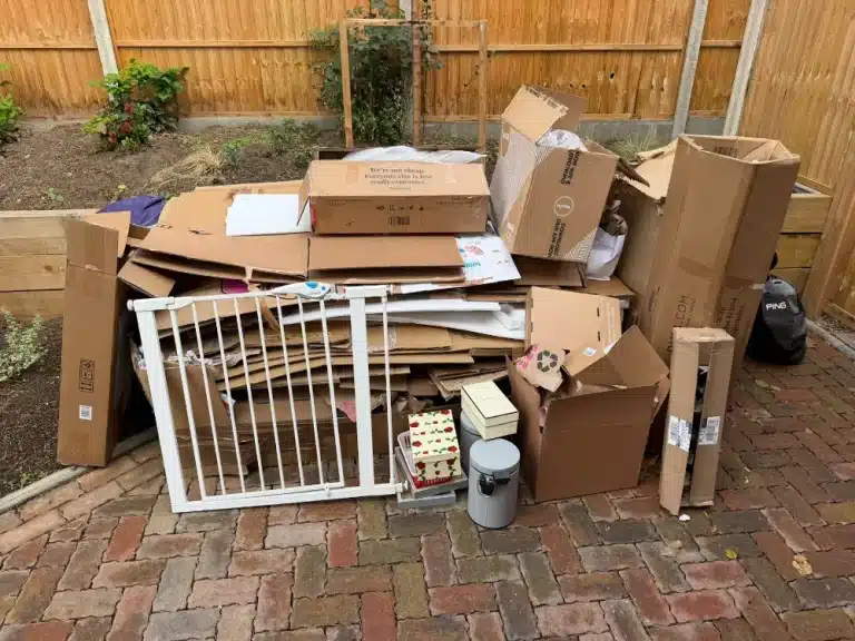 Rubbish Collection in Croydon 1 Cardboard boxes, bags and an old gate ready for collection on a Sanderstead patio