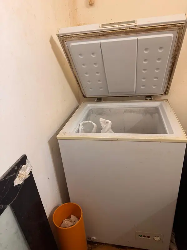 Can I Take My Old Fridge to the Tip? A London Guide 6 Old chest freezer in a small utility room, ready for collection