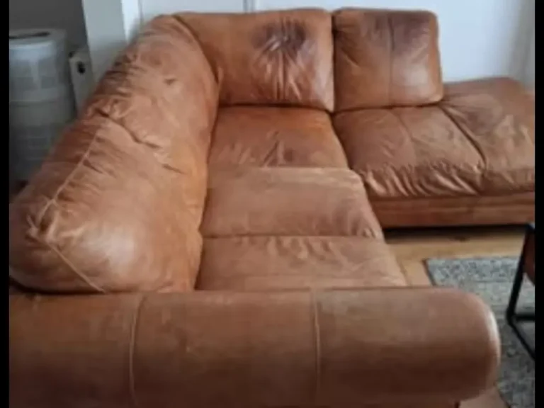Brown leather L-shaped sofa in a Clapton flat, ready for removal