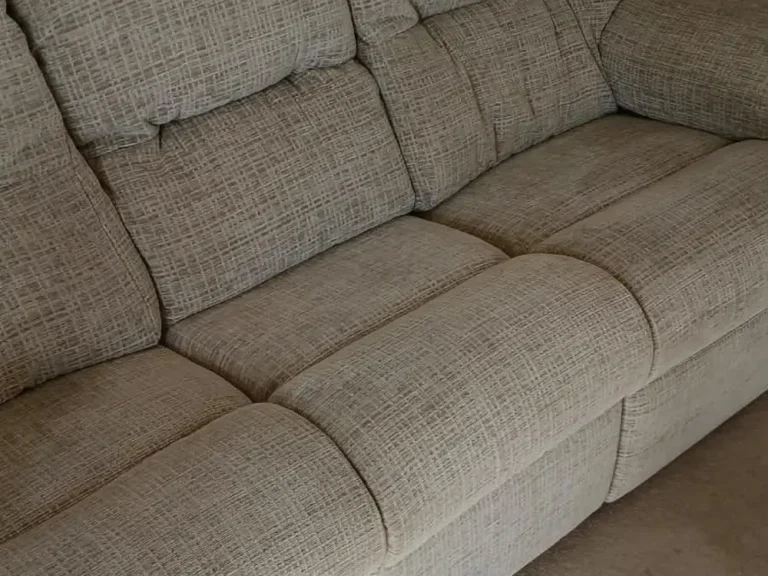 Beige fabric three-seater sofa in a Dalston living room, ready for collection