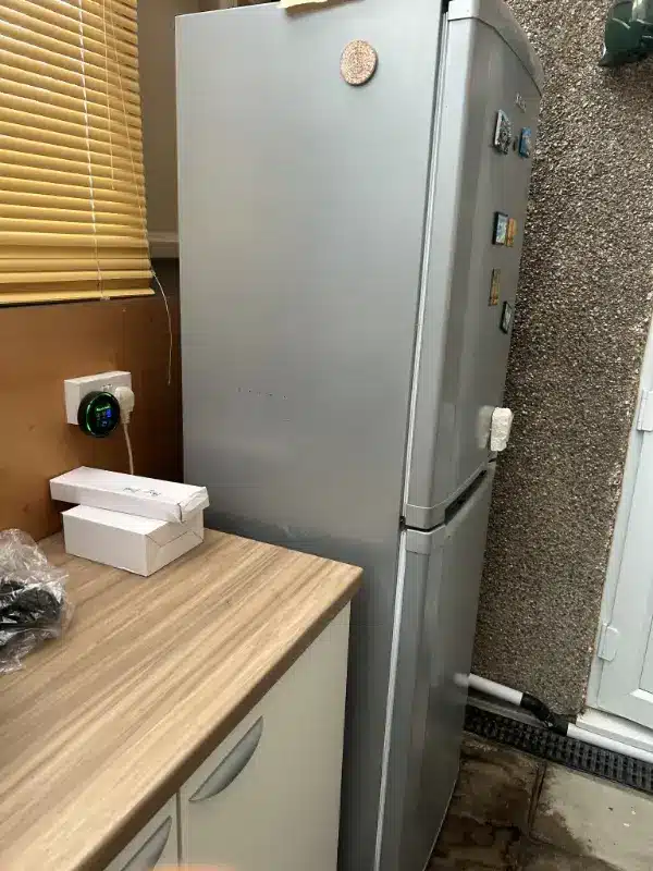Can I Take My Old Fridge to the Tip? A London Guide 4 Silver fridge freezer waiting by the back door in West Drayton for collection