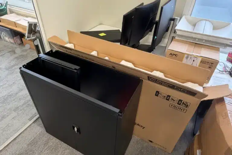 Old office cabinet, boxes and monitors cleared from a London office