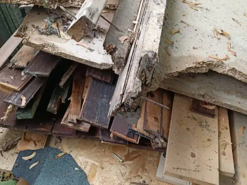 Rubbish Collection in Greenwich 4 Old timber and broken panels in a garden, ready to be loaded