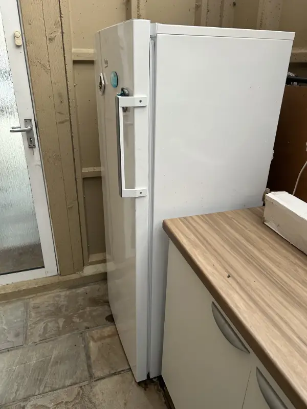 Can I Take My Old Fridge to the Tip? A London Guide 3 Tall white fridge in a side passage in West Drayton, one of two fridges we collected that morning