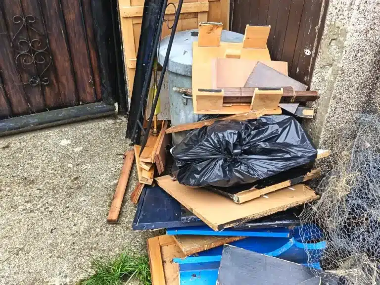 Rubbish Collection in Croydon 3 Old timber, bags and mixed rubbish by a side gate in New Addington before collection